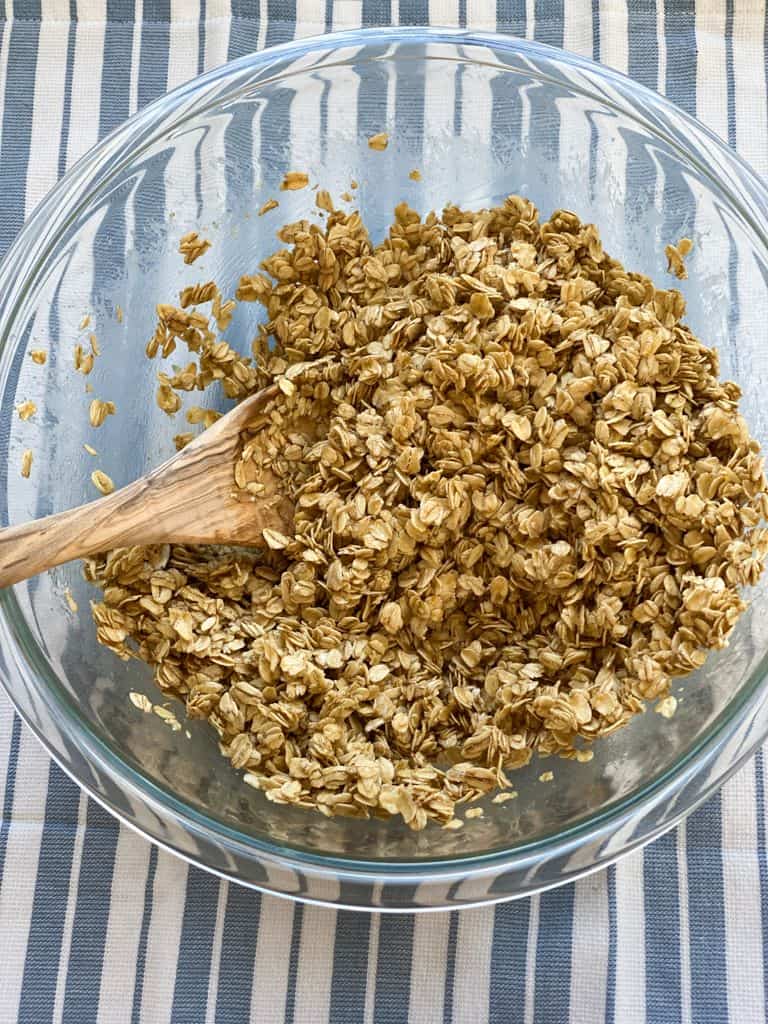 bowl of oats honey butter mixed together to make granola