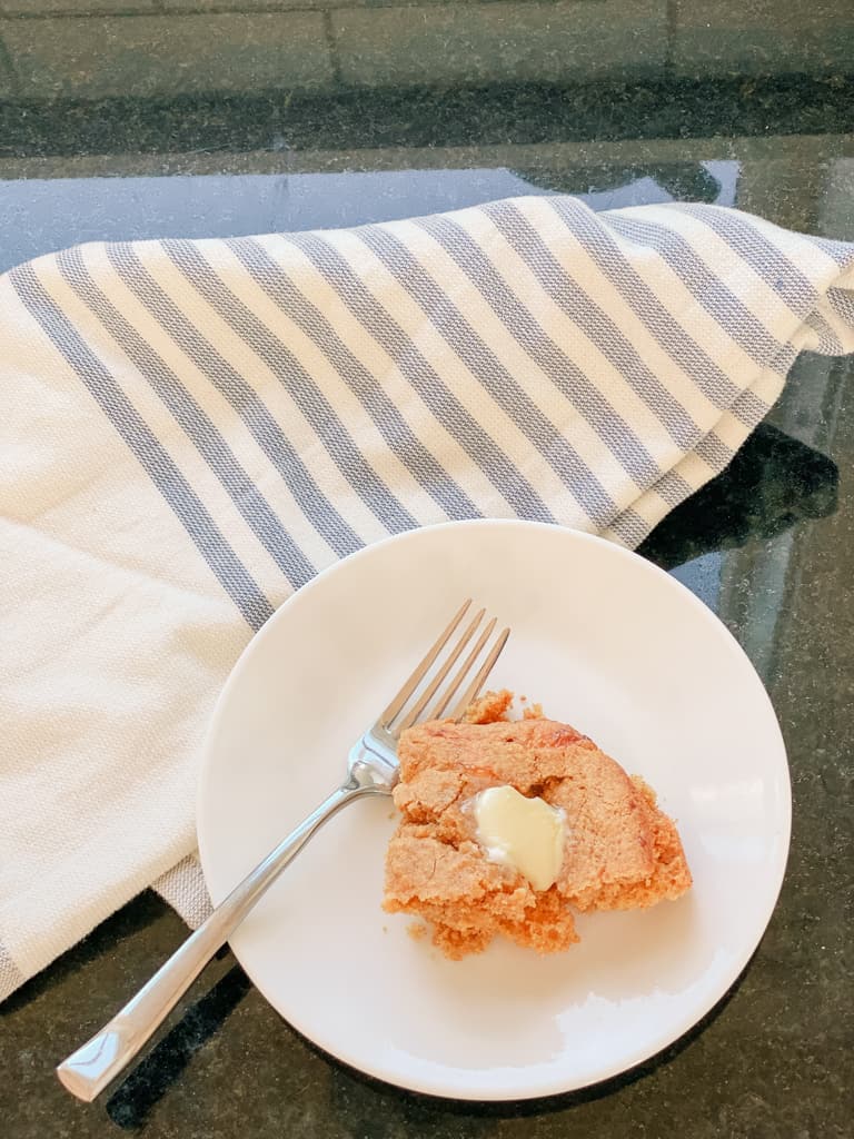 plate fork piece of cornbread kitchen counter table dishtowel butter grass fed cornbread sourdough einkorn