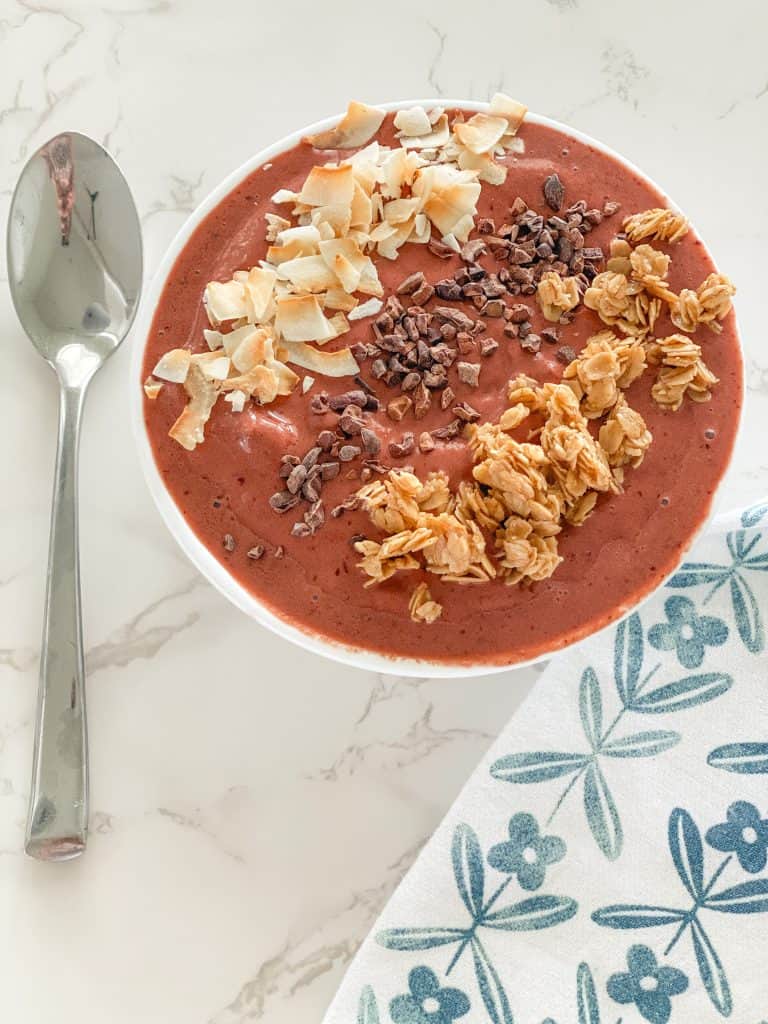 smoothie bowl with toppings and spoon