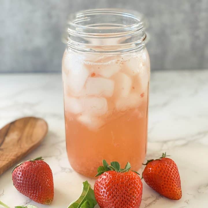 mason jar filled with strawberry basil iced tea