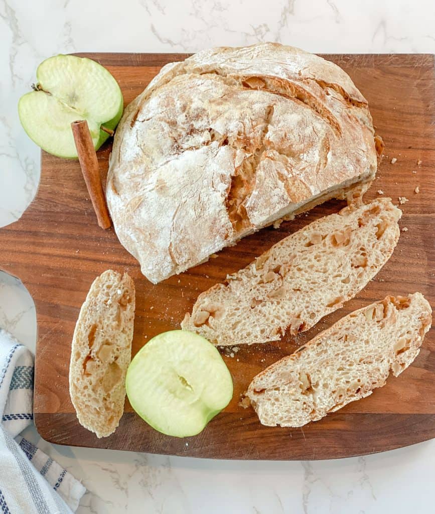 sliced sourdough apple bread on wood cutting board