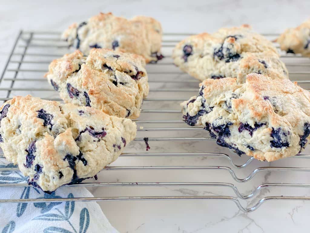 sourdough blueberry scones cooling on bakers rack