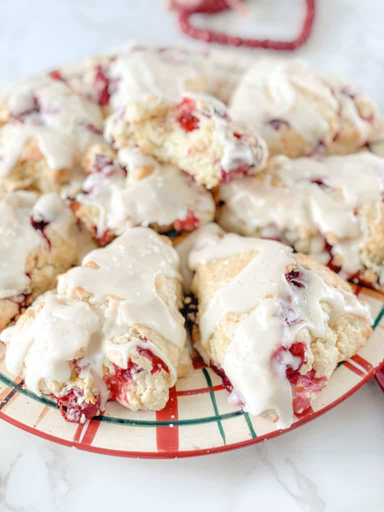 glazed orange cranberry sourdough scones on Christmas plate