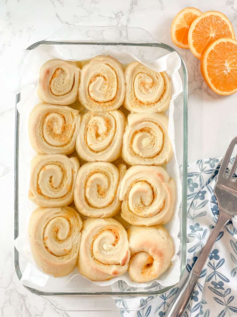 baked orange sourdough rolls in pan without glaze