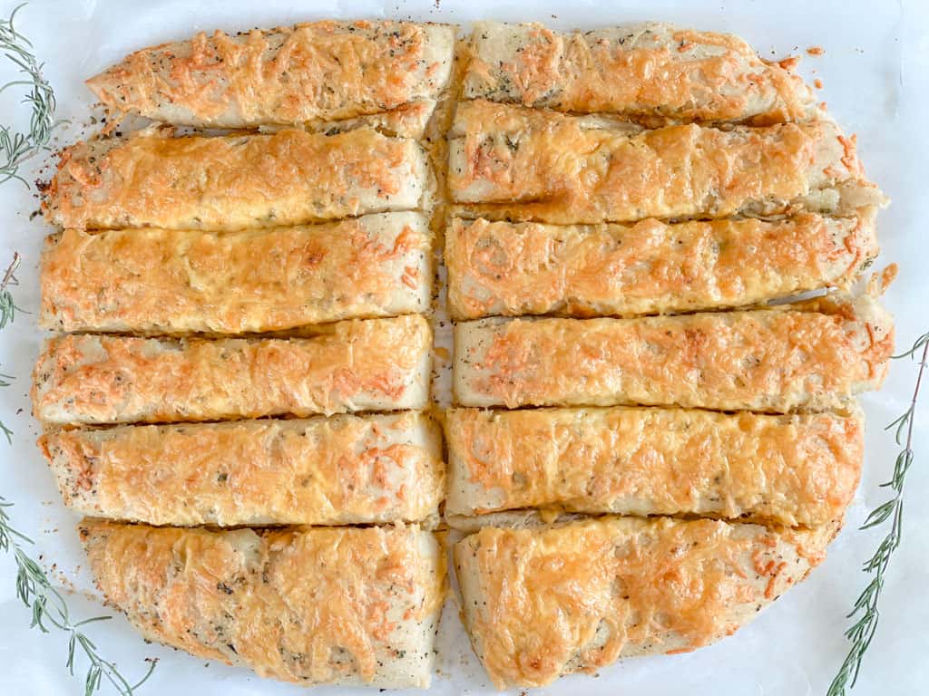 baked sourdough cheese sticks with sprigs of rosemary for decoration